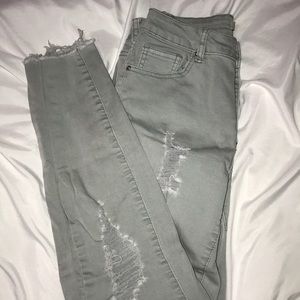 A pair of light green skinny jeans